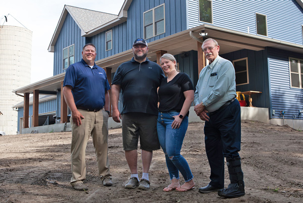 Loan Officer Tony Bentz (far left) and Bruce Mathwig (far right) with Scott and Erin Worm